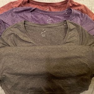 3 pack, women’s size large workout shirts.